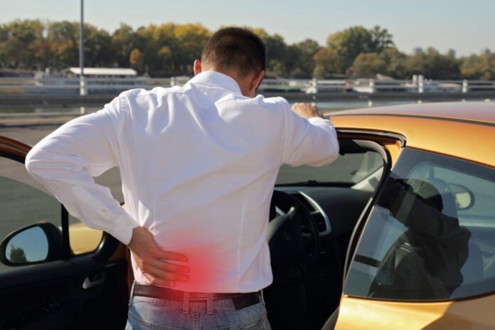Man with back pain after long car drive. Incorrect sitting posture problems ,Muscle spasm, rheumatism. Pain relief, ,chiropractic concept.