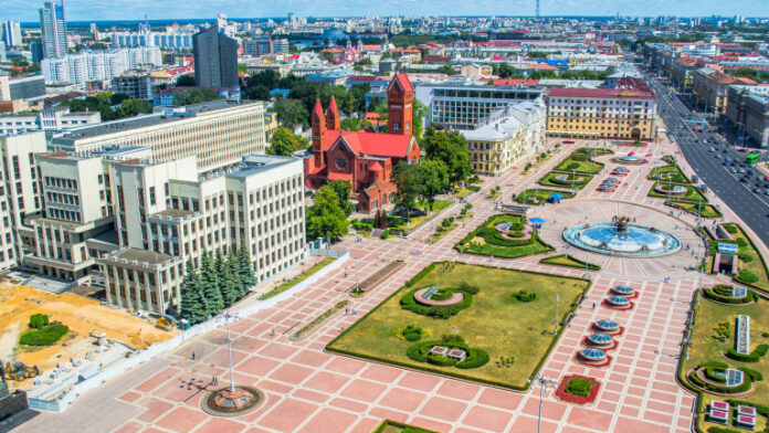 White Government Parliament Building And Lenin Statue on Independence Square in Minsk, Belarus
